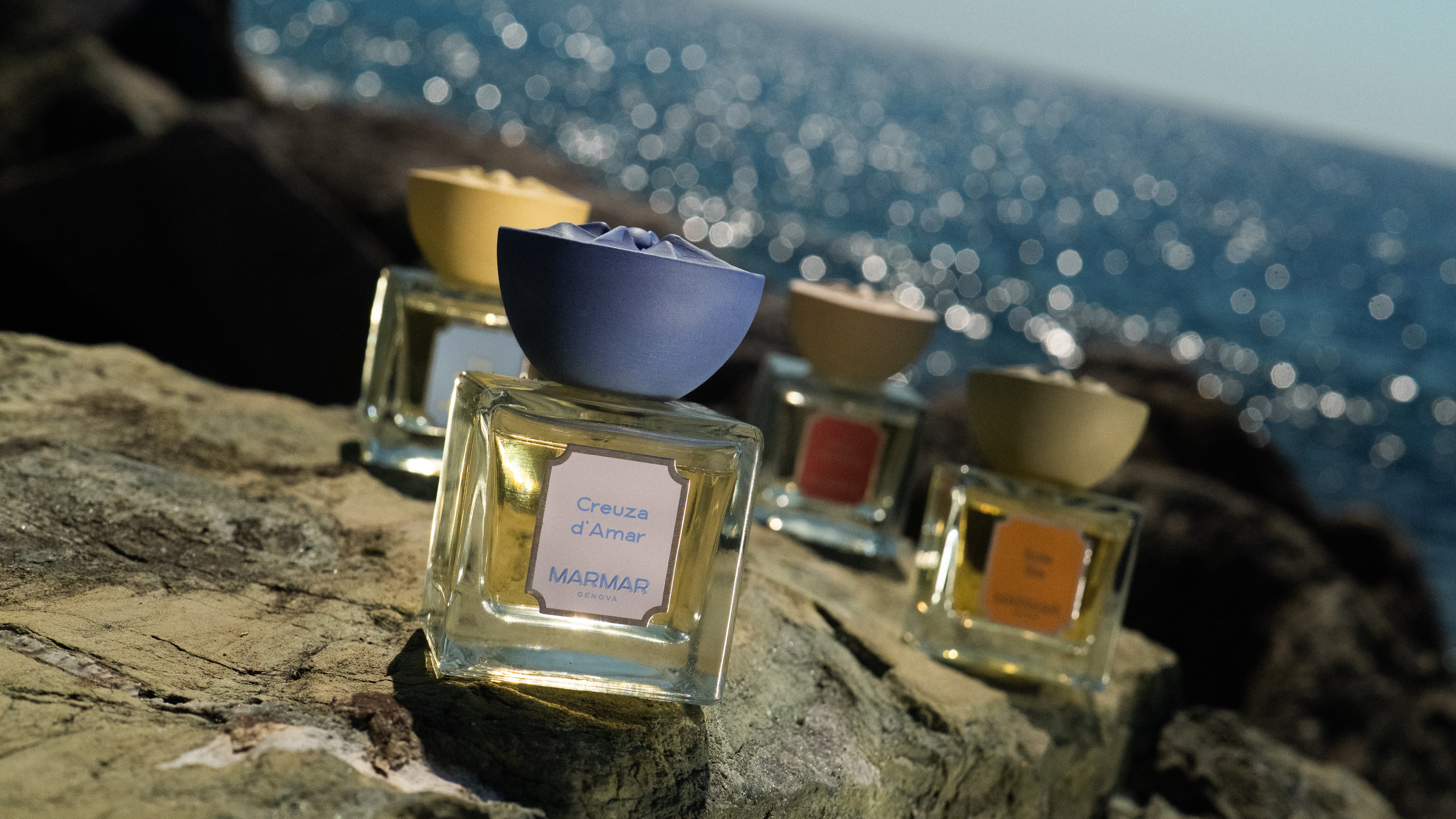 MarMar Genova Eau de Parfum collection of bottles against a sea horizon in Liguria