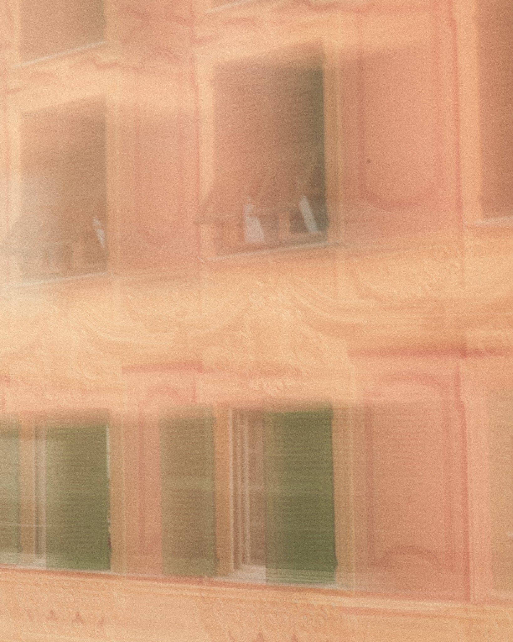 Blurry shot of a pink and cream architectural façade of a Genoese palace for MarMar Genova shot by Filippo Fornasini
